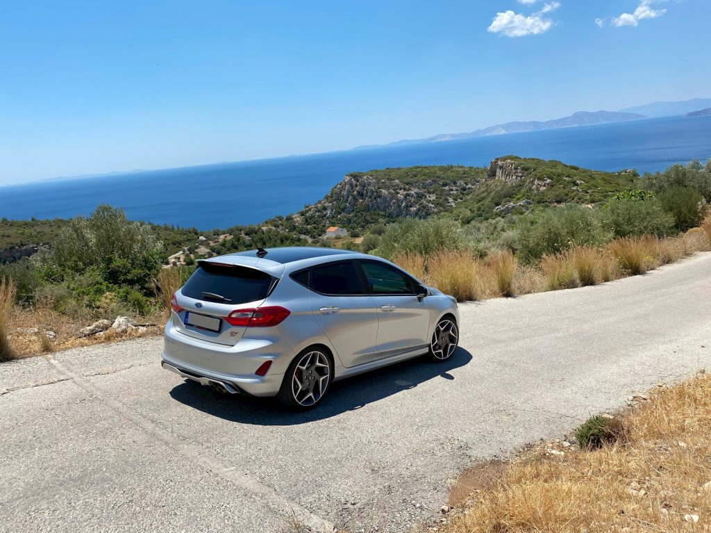 a white car parked on the side of a road