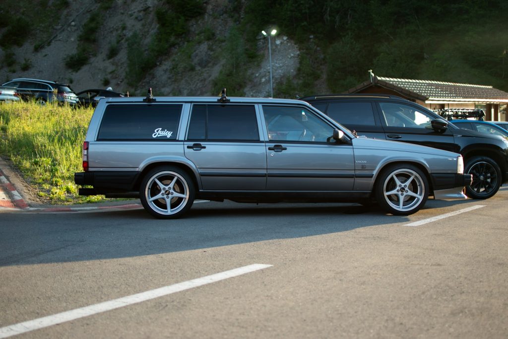 A line of cars parked on the side of a road