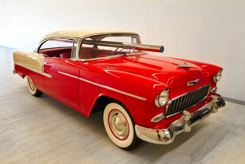 a red and white car parked in a garage