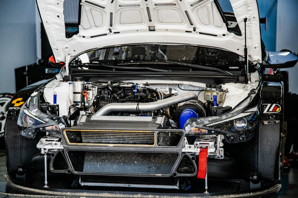 White race car engine compartment with hood open