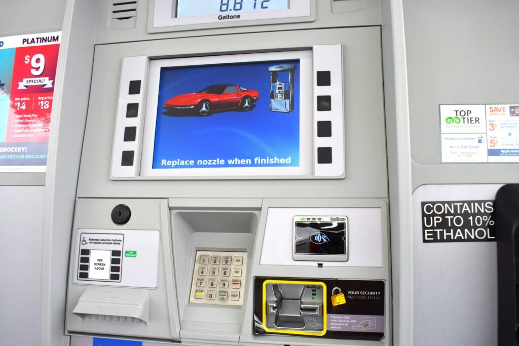 a gas pump with a picture of a red car on it