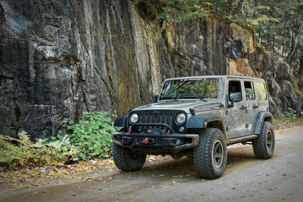 gray SUV passing by a rough road