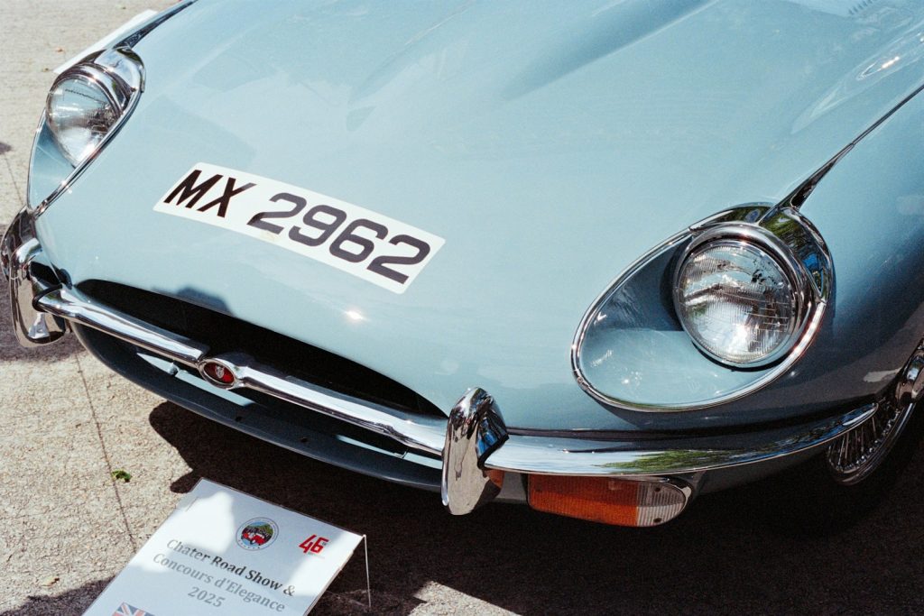 Close-up of a light blue vintage car's front.