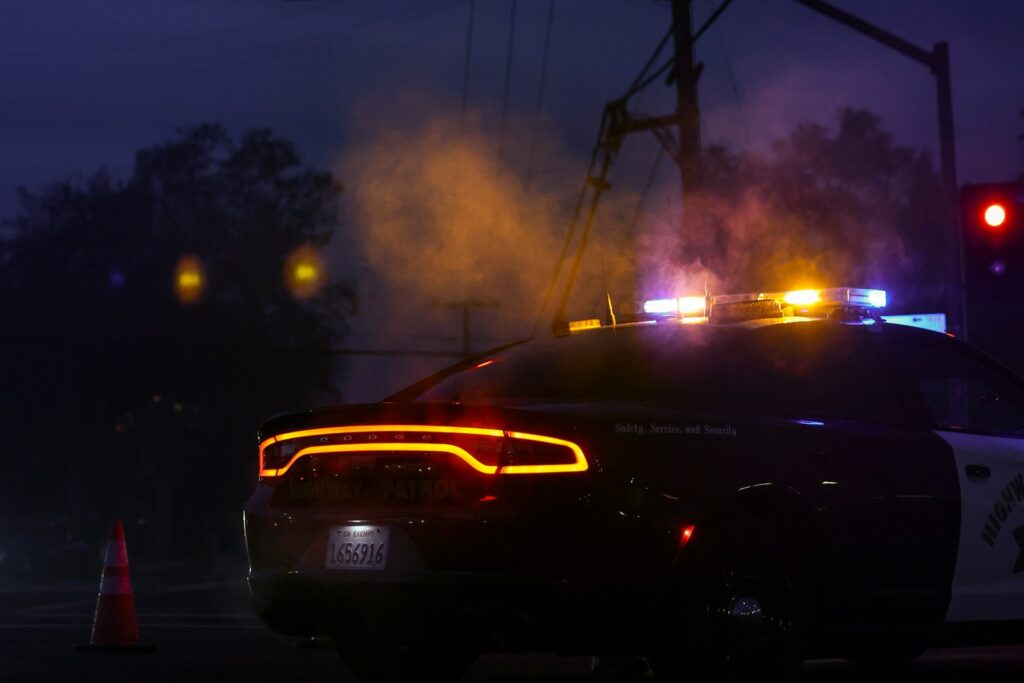 A police car with its lights on at night