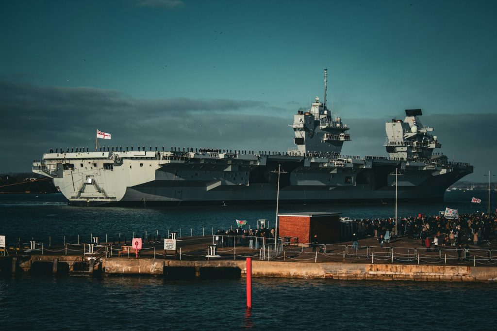a large ship in the water near a dock