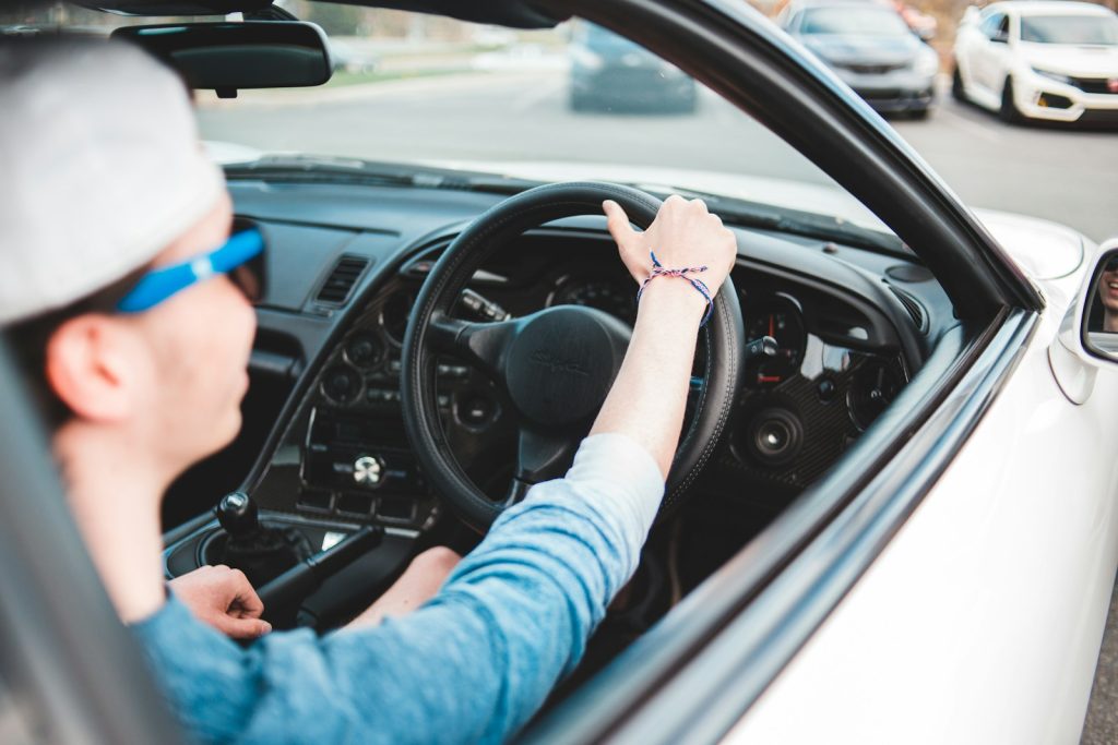 person in blue long sleeve shirt driving car