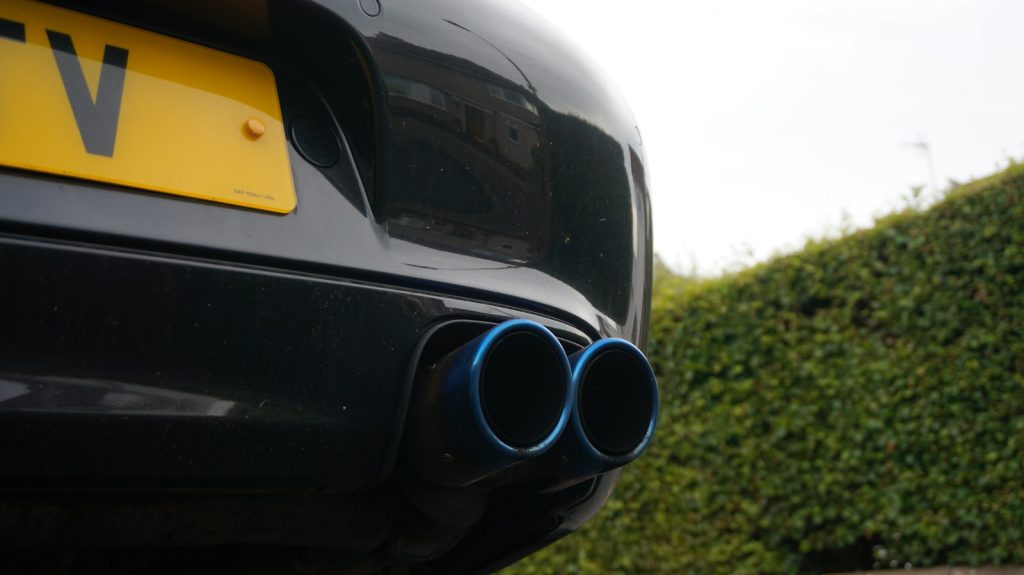Close-up of blue exhaust pipes on a car.