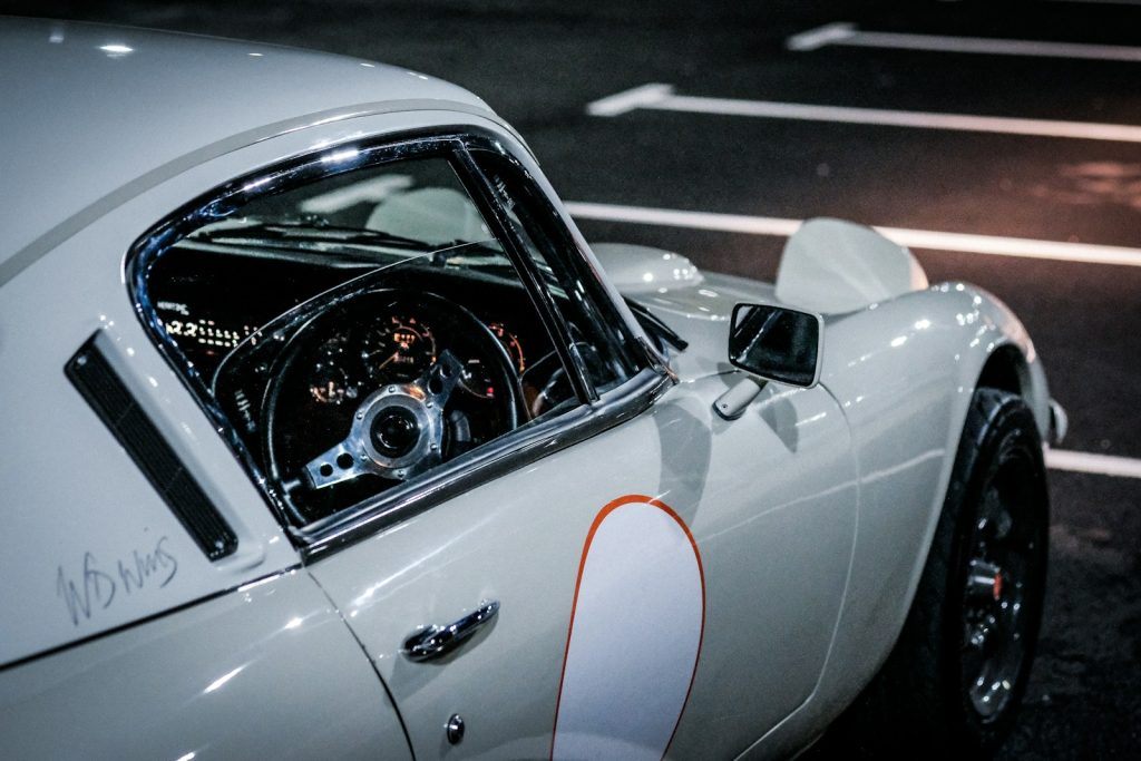 a close up of a sports car parked in a parking lot
