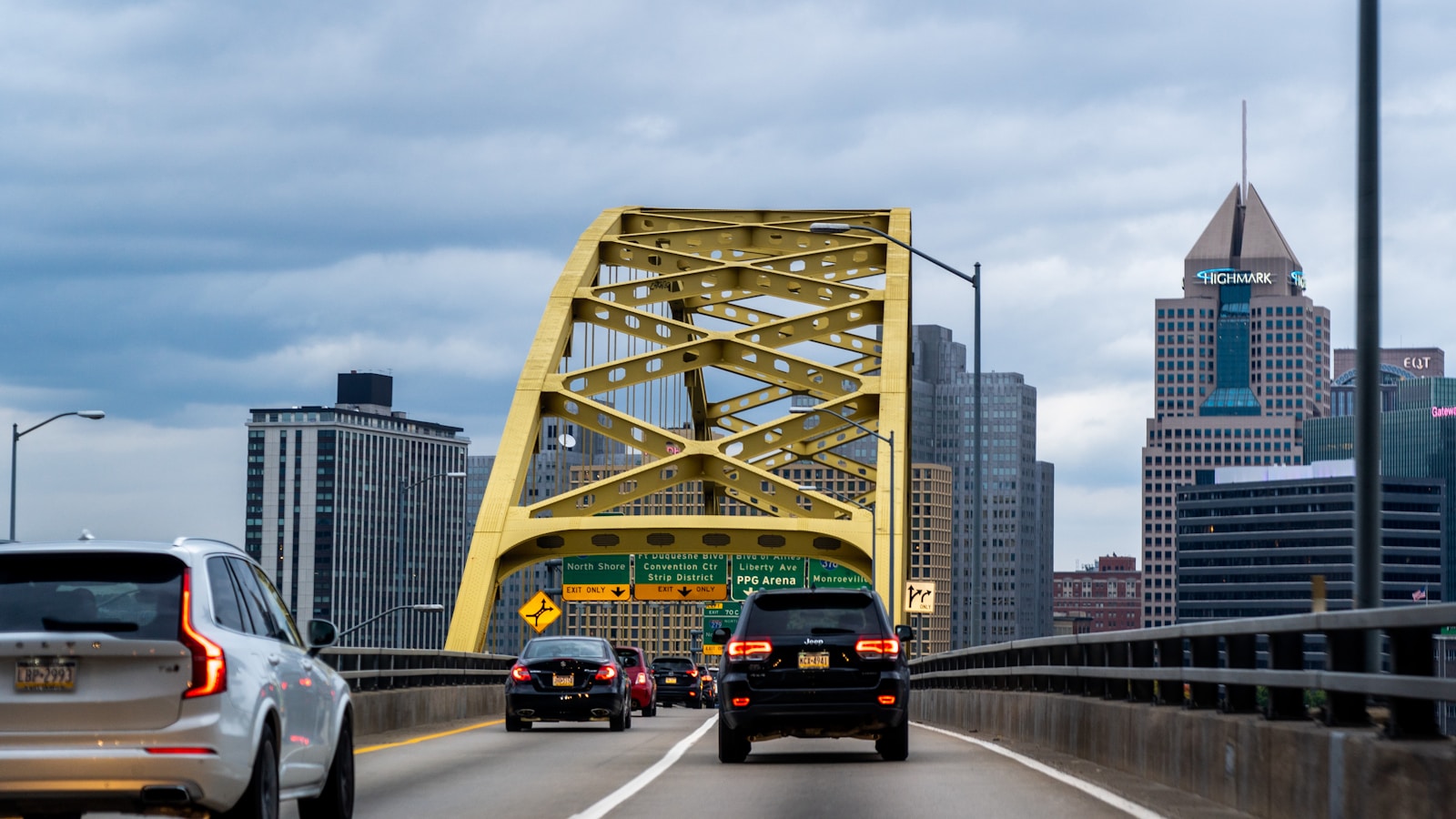 cars on road near bridge during daytime