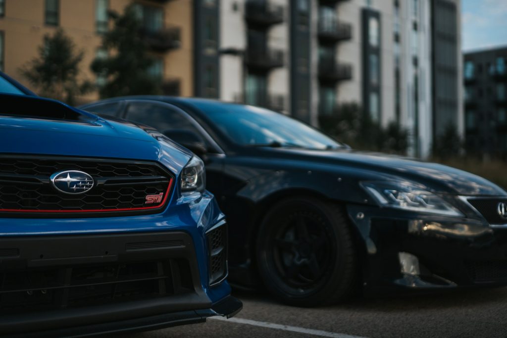 a couple of cars parked on the side of a street