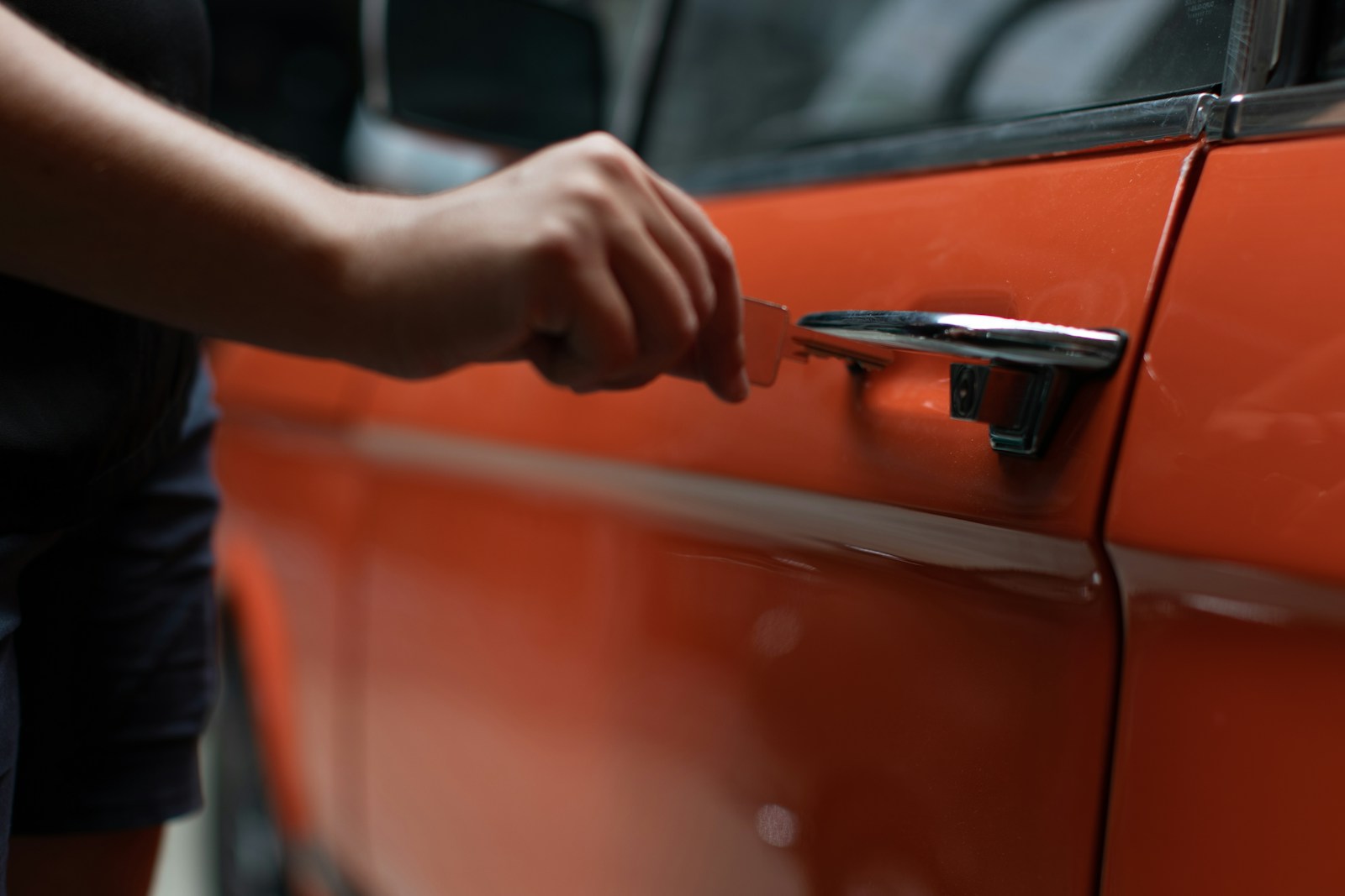 a person opening a car door