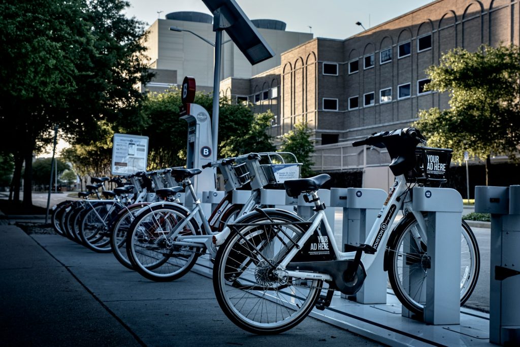 black and silver bicycle parked on sidewalk during daytime