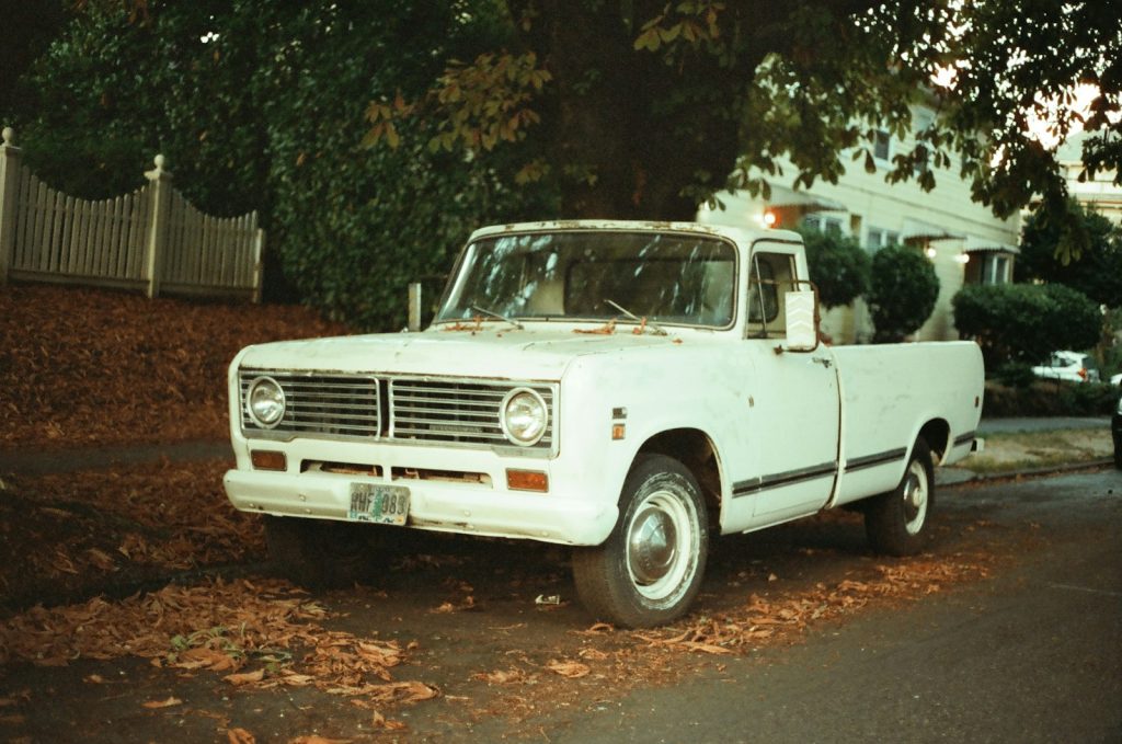 a white truck parked on the side of a road