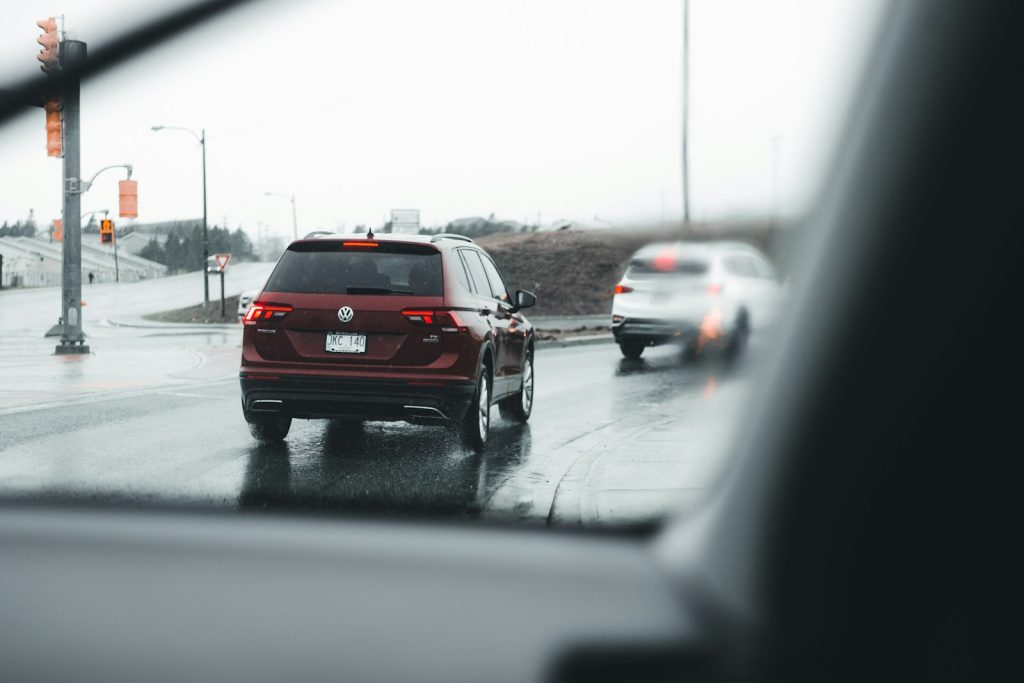 red suv on road during daytime