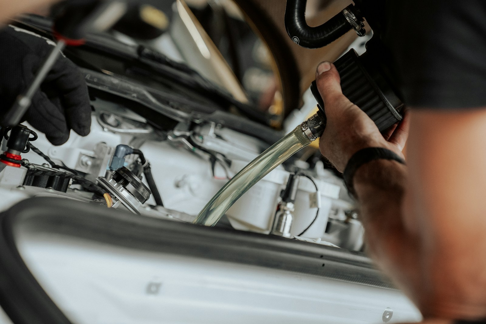 Mechanic works on a car's engine components.