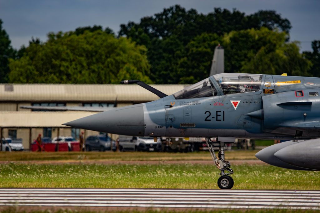 A fighter jet sitting on top of an airport runway