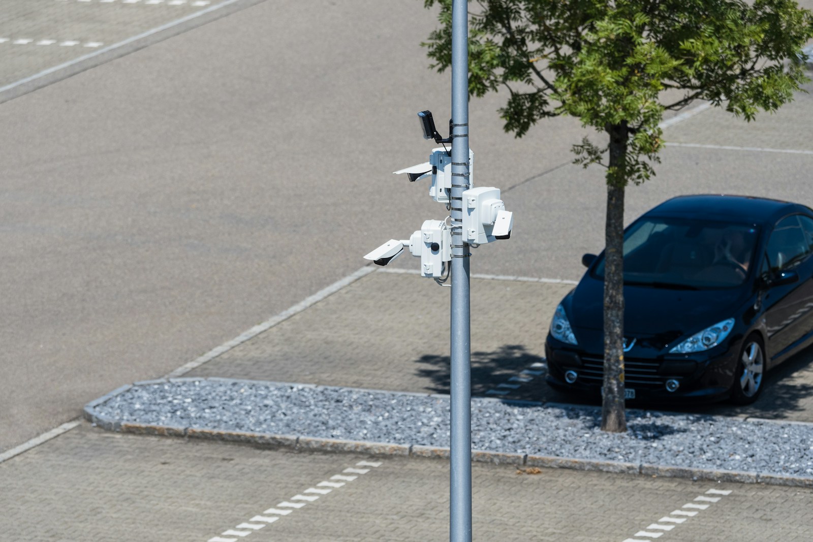 Security cameras monitor a parking lot.