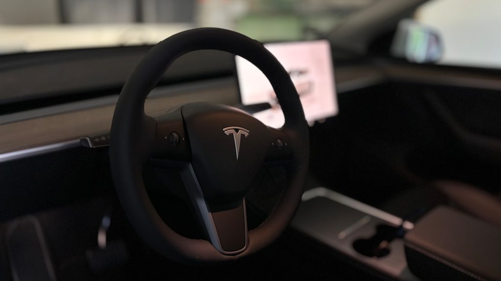 A tesla's steering wheel and interior.