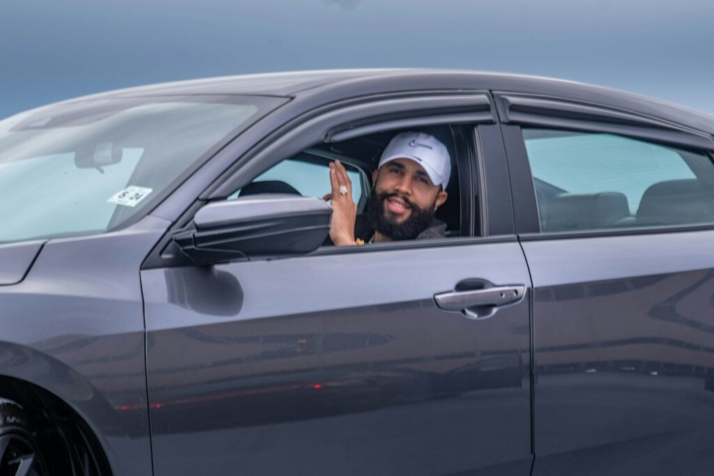 man in black car during daytime