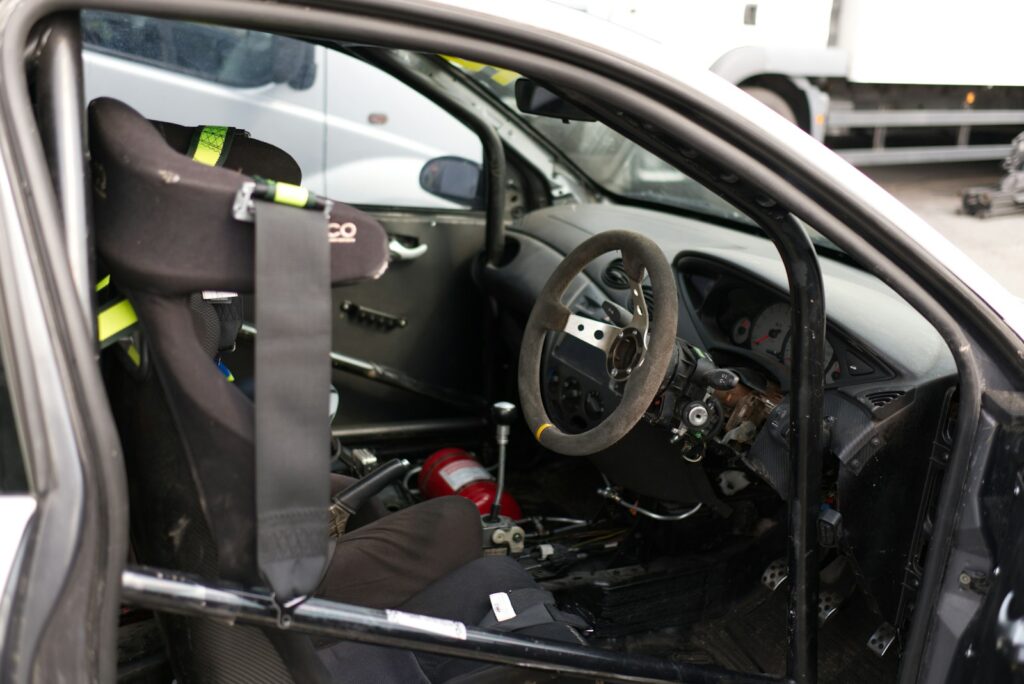 Interior of a race car with racing seat and roll cage