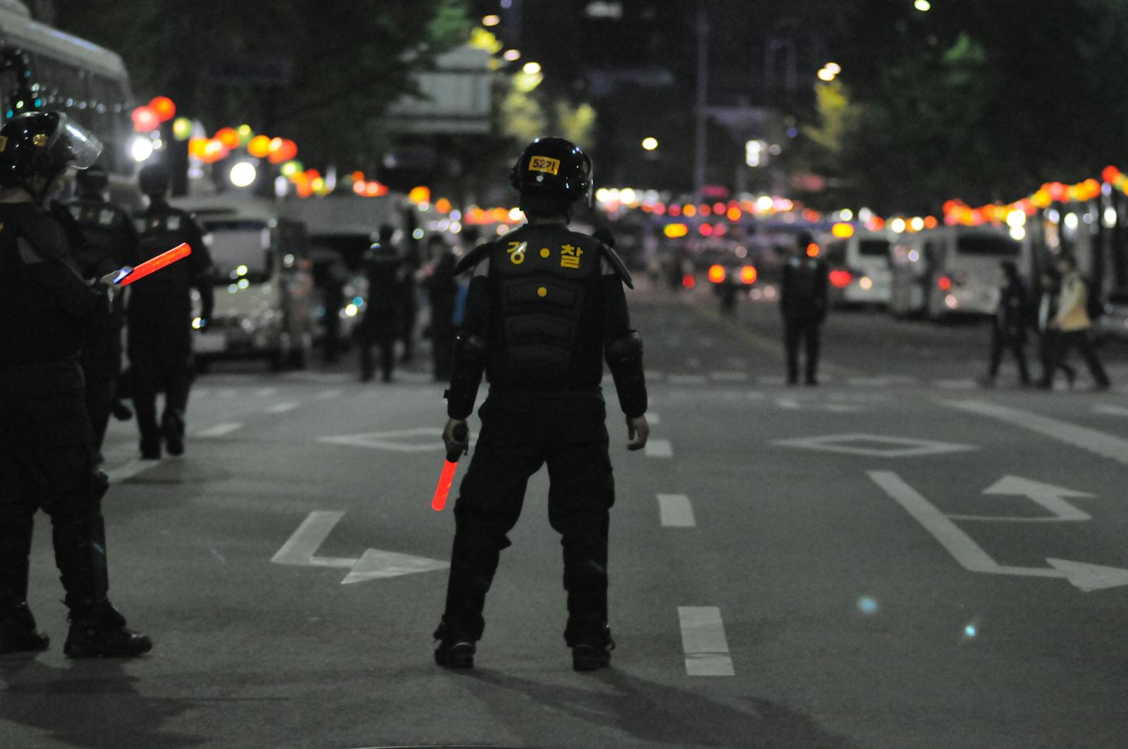 Police officers maintaining order during a night street patrol, ensuring public safety.
