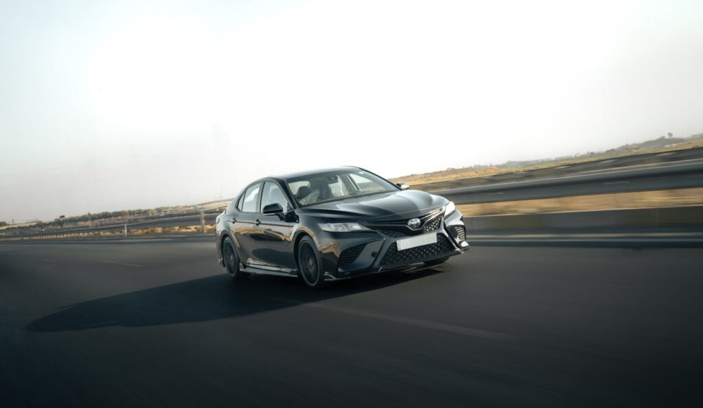 A sleek Toyota Camry in motion on a highway, capturing the essence of speed and style.