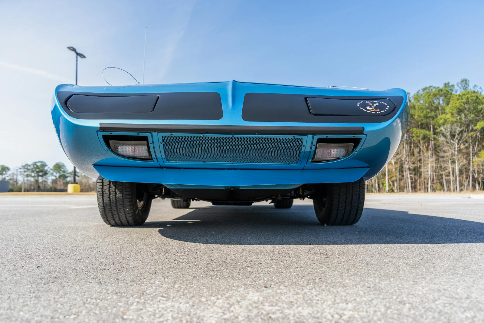 Iconic Plymouth Superbird car's front view captured outdoors in Madisonville, Louisiana.