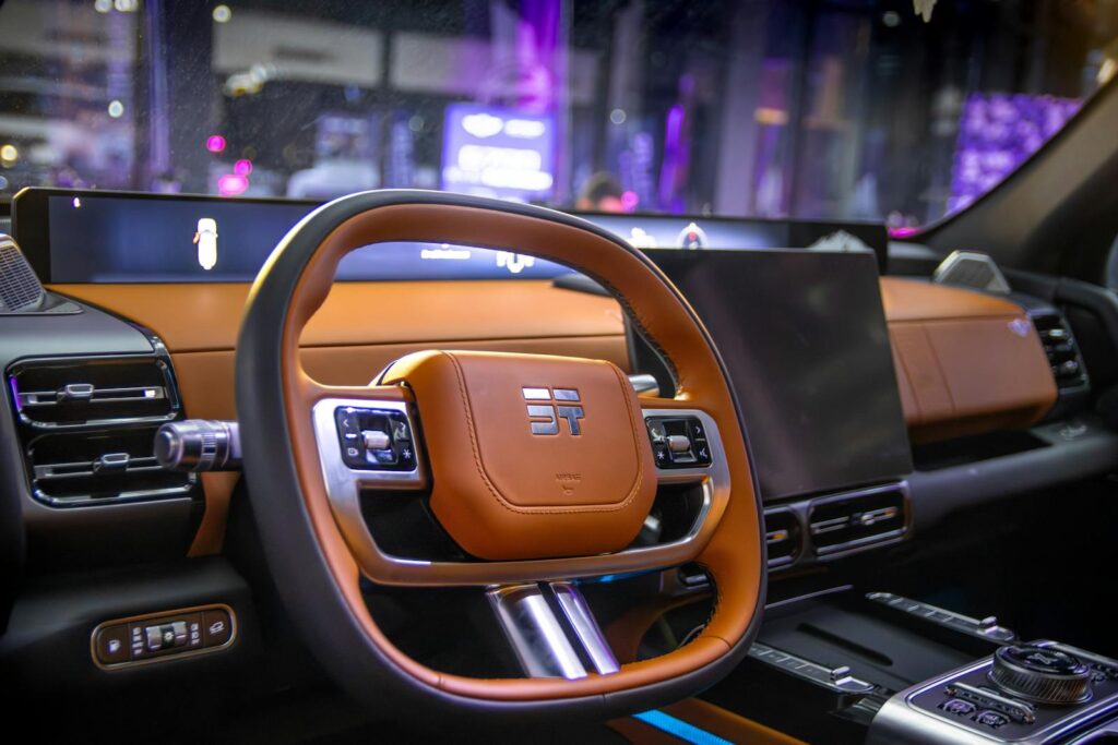 Close-up of a modern luxury car interior showcasing a high-tech steering wheel and dashboard.