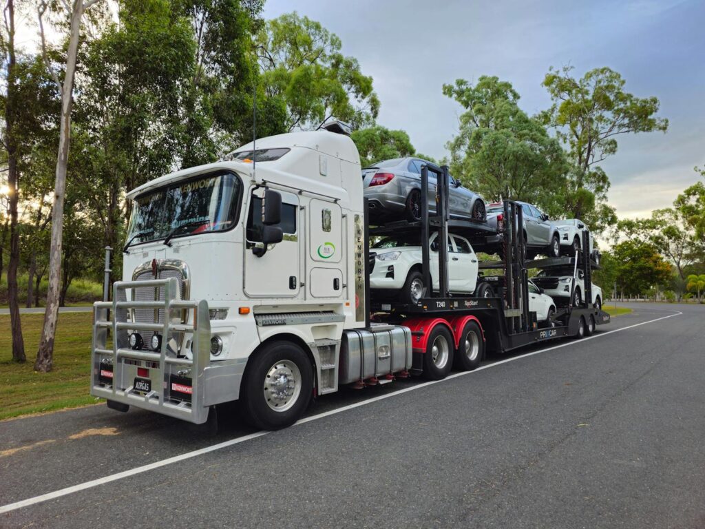 Large car carrier truck transporting vehicles on a road in Heathwood, Queensland.
