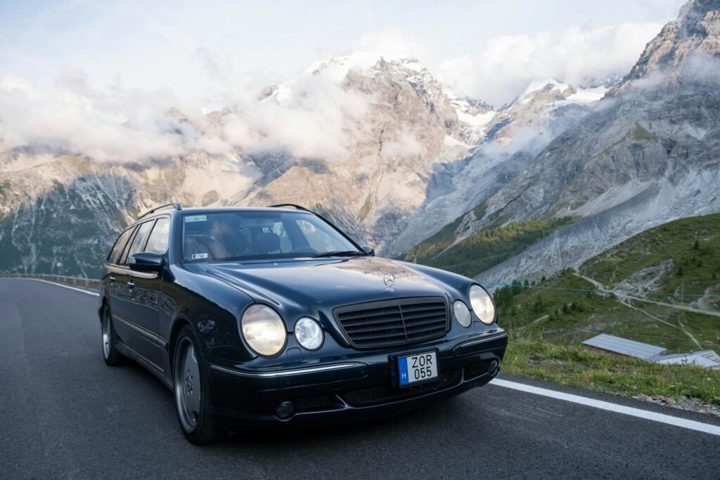 Black car driving on a mountain road