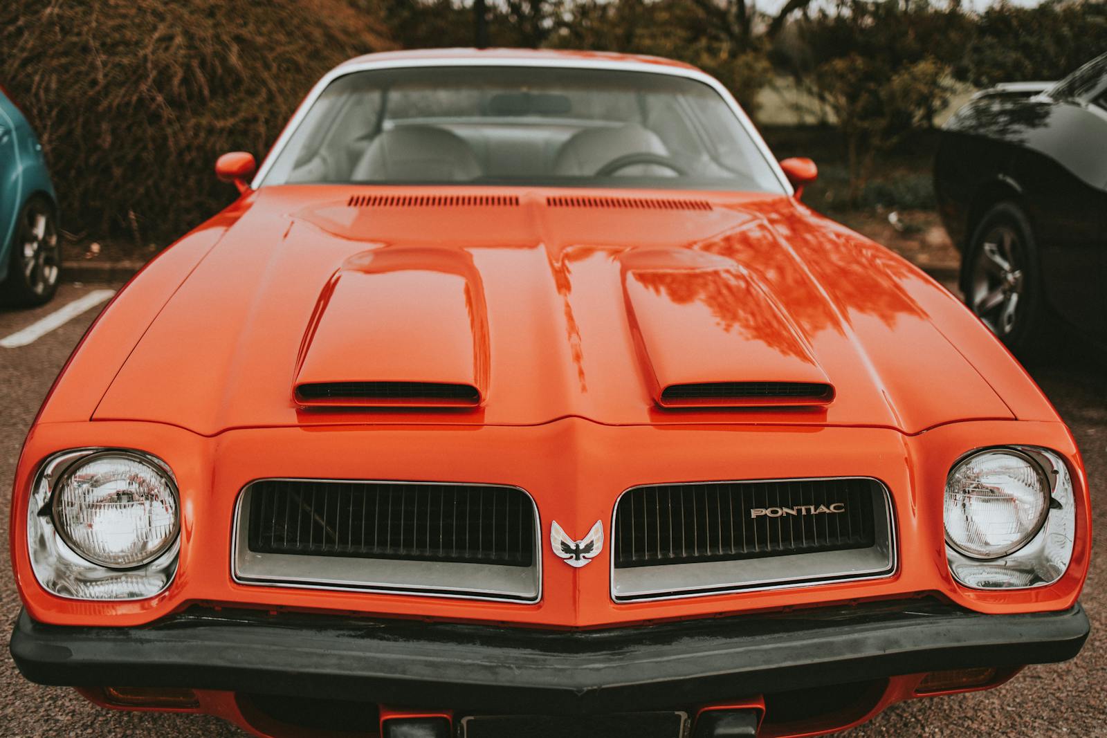 Close-up of a vintage orange Pontiac car parked outdoors in Aberdeen, Scotland.