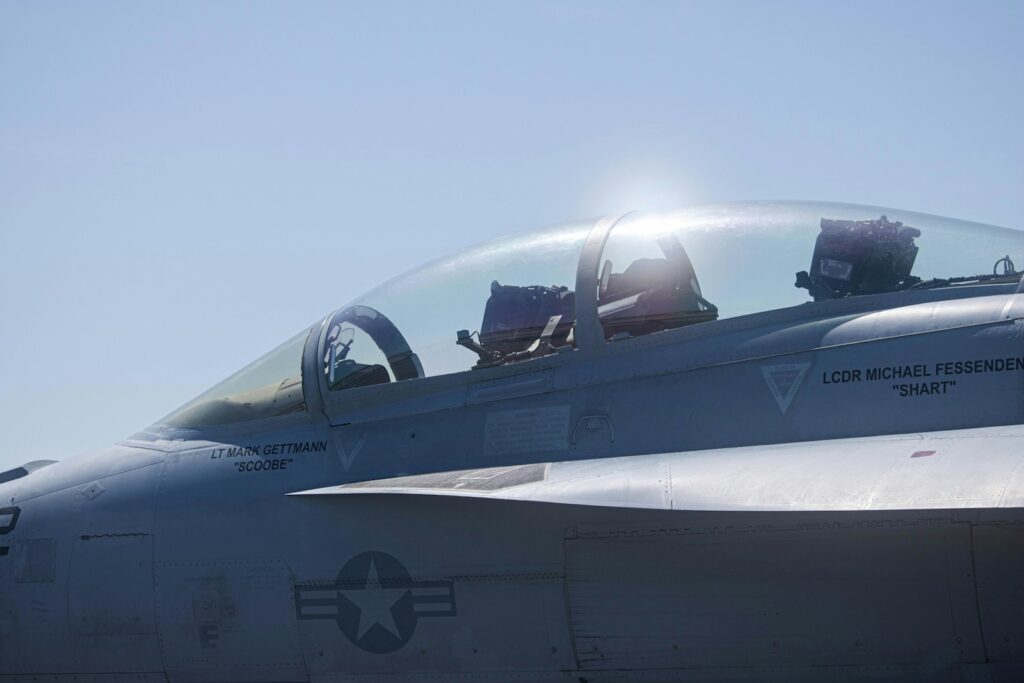 a fighter jet sitting on top of an airport tarmac