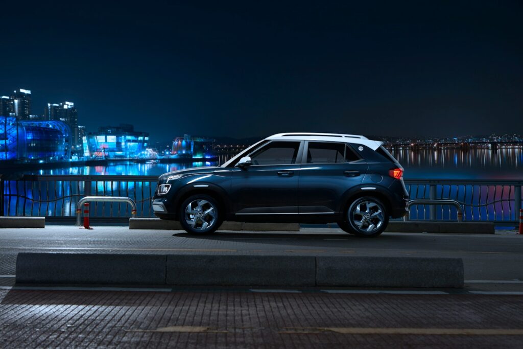 a car parked on the side of the road at night