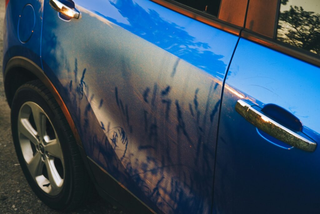 A blue car parked on the side of the road