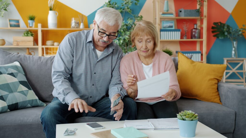 Elderly couple reviewing documents at home
