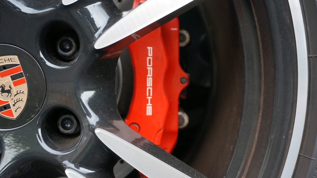 Red porsche brake caliper and wheel detail