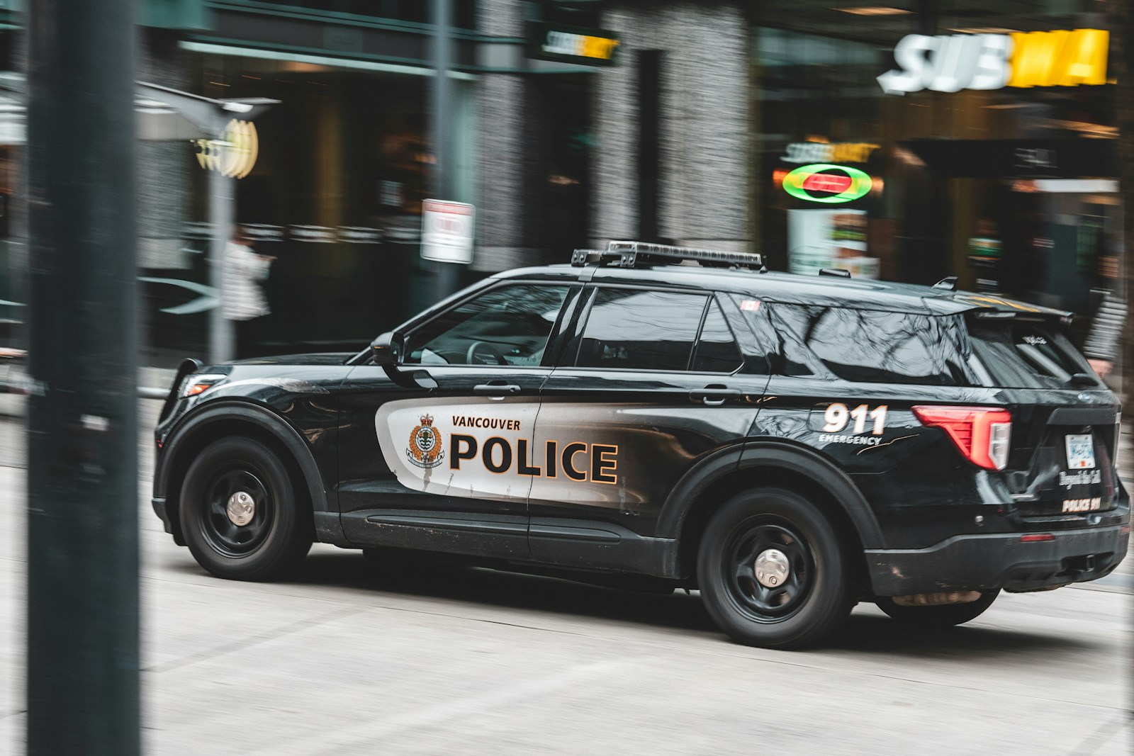 a police car driving down a city street