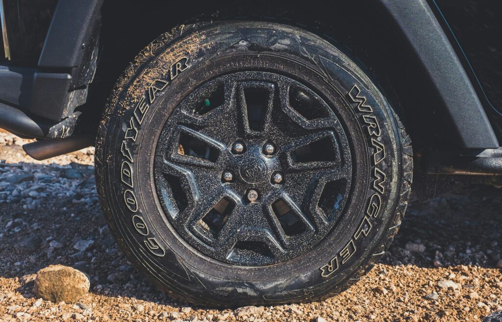 black vehicle wheel with Wrangler tire