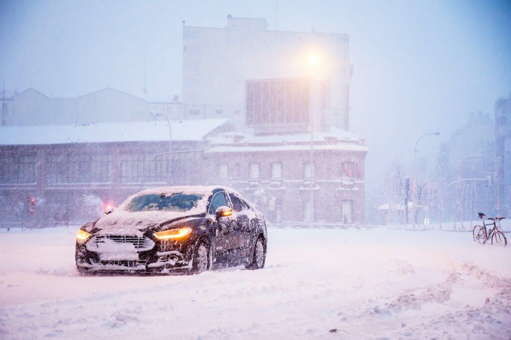 yellow and black sports car on snow covered road during daytime