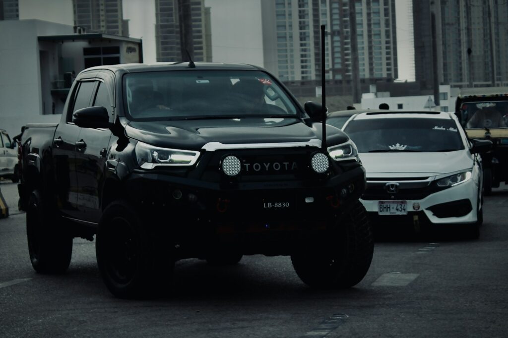 Black toyota pickup truck driving on a street
