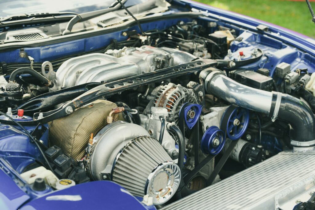 Close-up of a modified car engine with turbocharger.