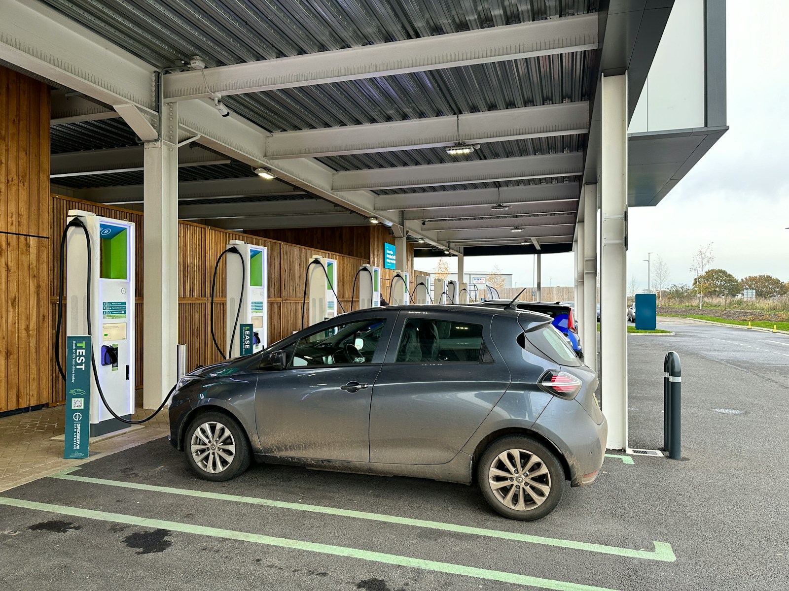 a silver car is parked at a gas station