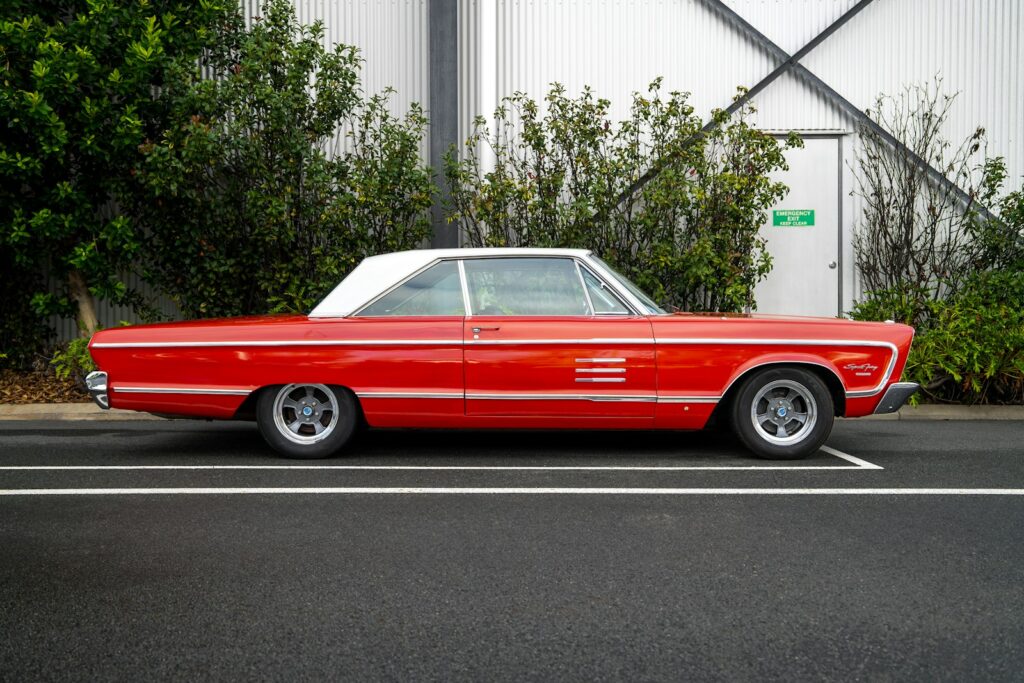 A classic red car is parked.