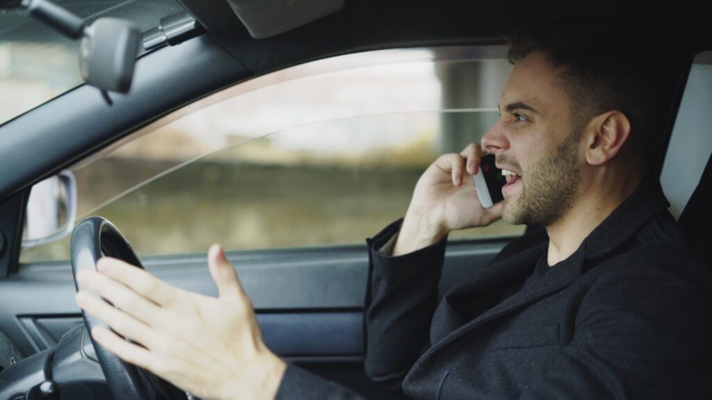 Man talking on phone while driving car
