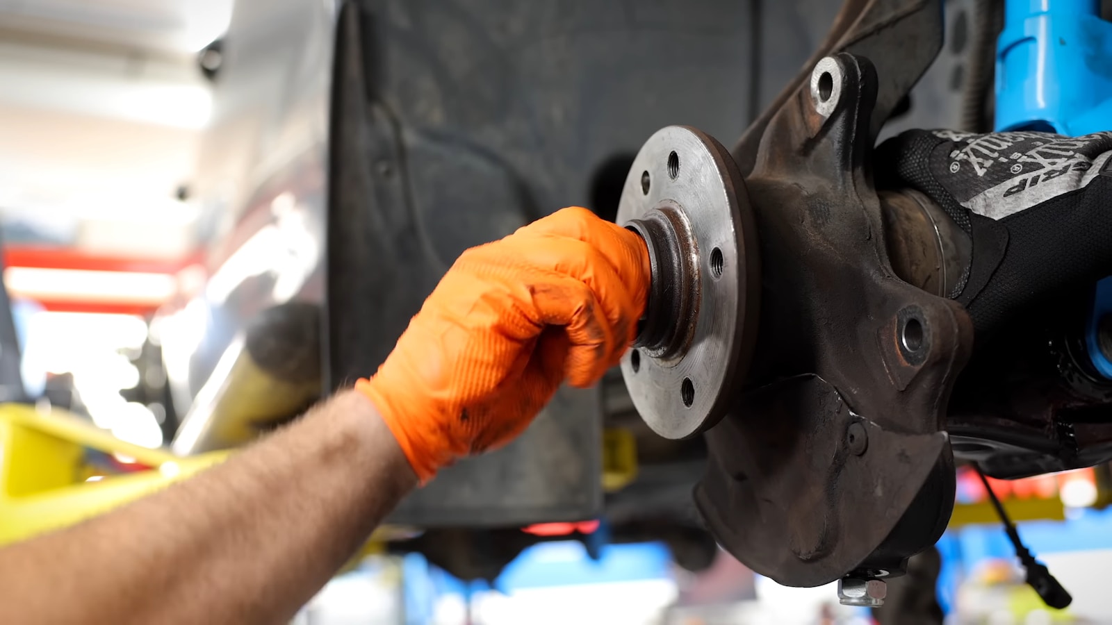 A man working on a vehicle in a garage