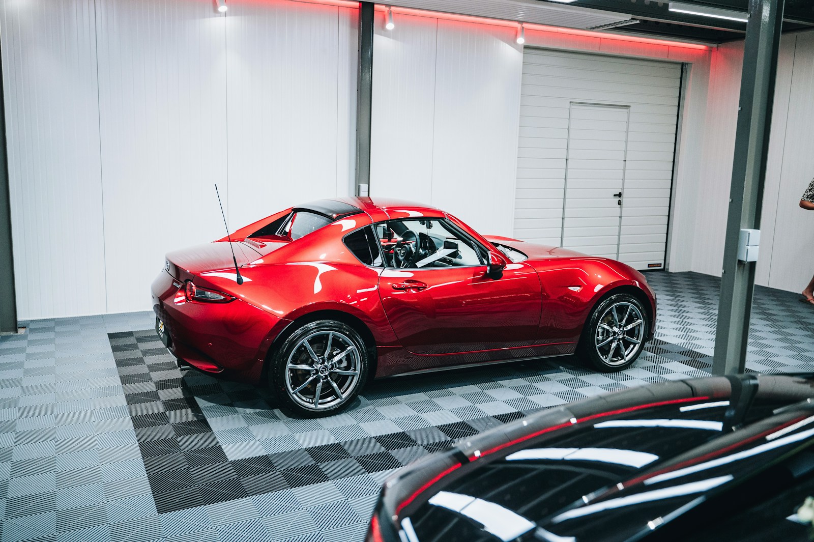 a red sports car parked in a garage