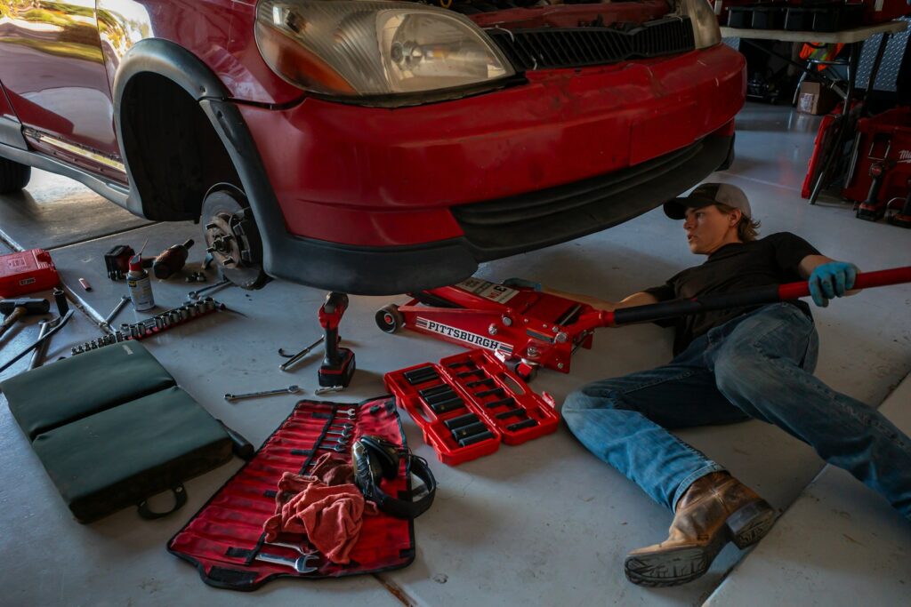 a man working on a car in a garage