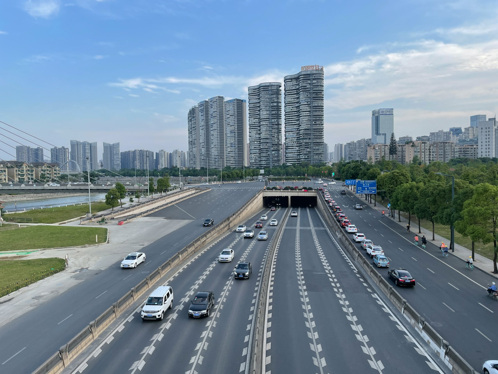 cars on road near city buildings during daytime