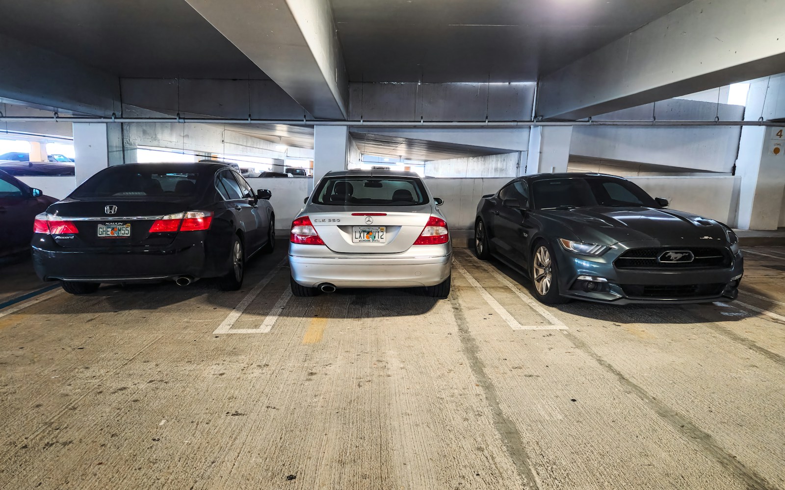 A group of cars parked in a parking garage