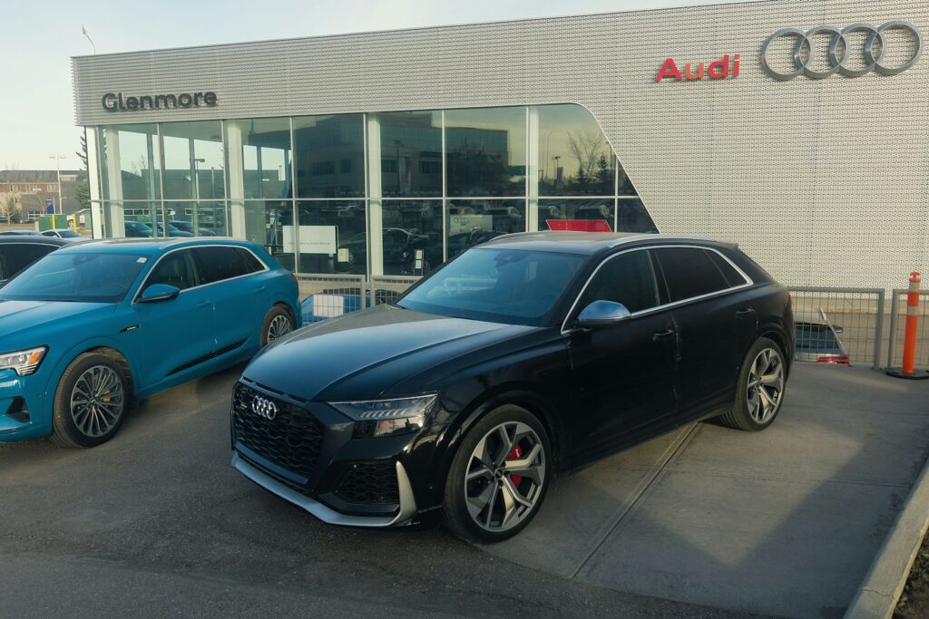 blue bmw m 3 coupe parked near building during daytime